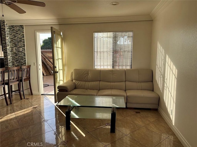 tiled living room with ceiling fan and ornamental molding