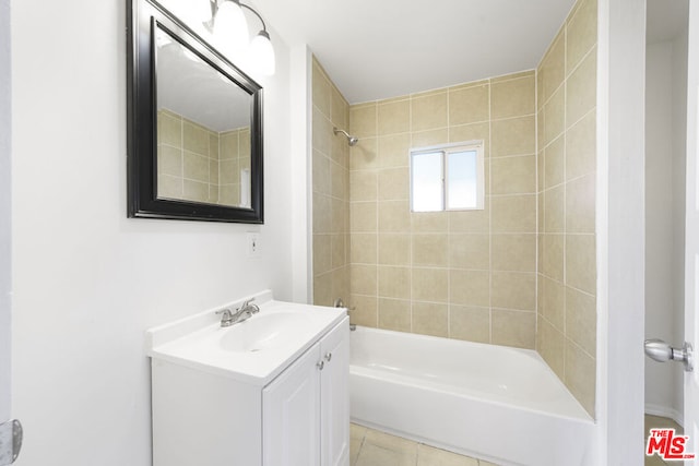 bathroom featuring tile patterned flooring, tiled shower / bath combo, and vanity