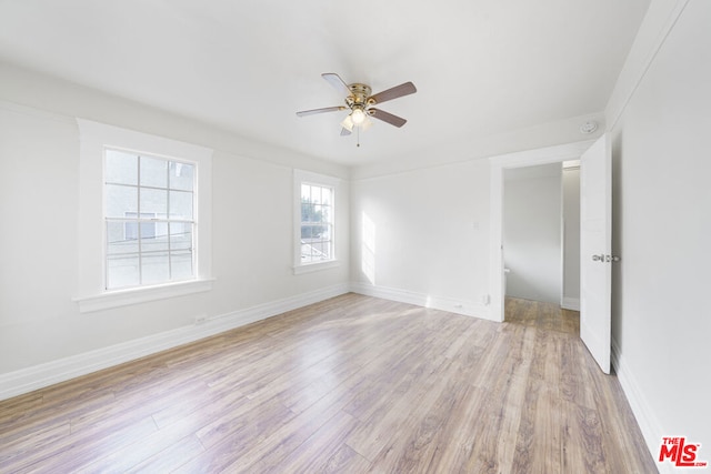 empty room featuring light hardwood / wood-style flooring, plenty of natural light, and ceiling fan