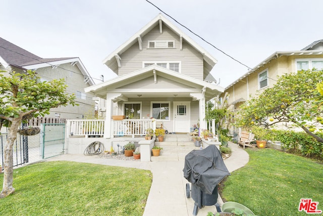 view of front of home with a porch and a front yard