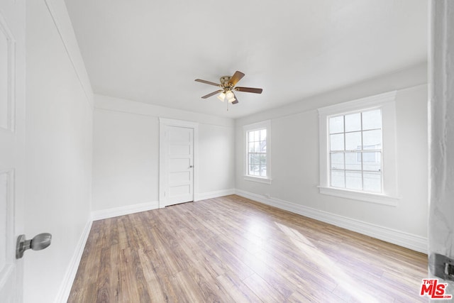 unfurnished room with ceiling fan and light wood-type flooring