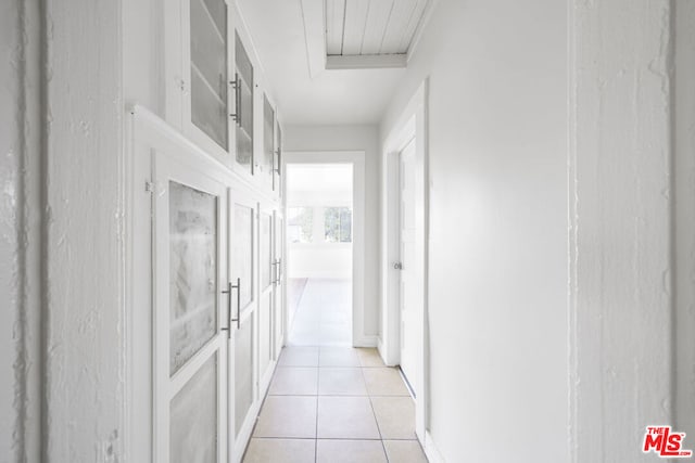 hall featuring light tile patterned flooring