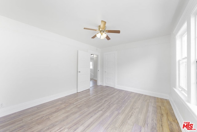 spare room with light hardwood / wood-style flooring and ceiling fan