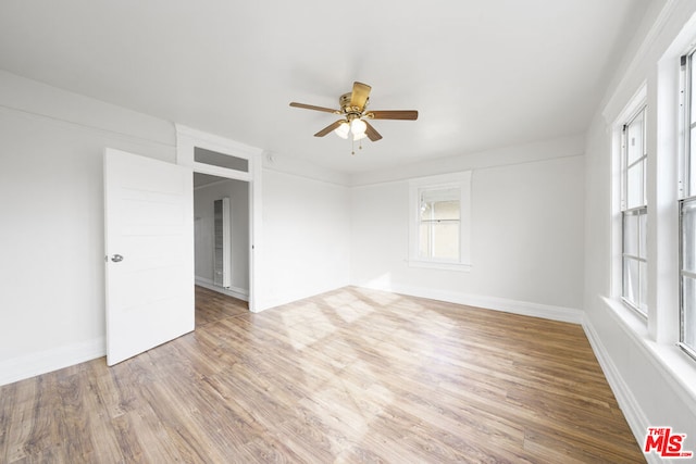 empty room featuring ceiling fan and hardwood / wood-style flooring