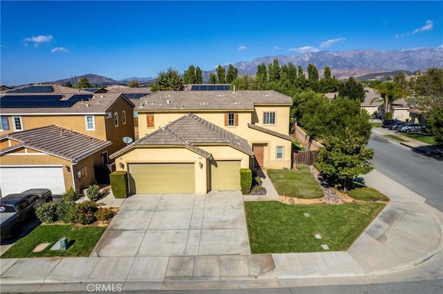 front of property featuring a mountain view and a garage