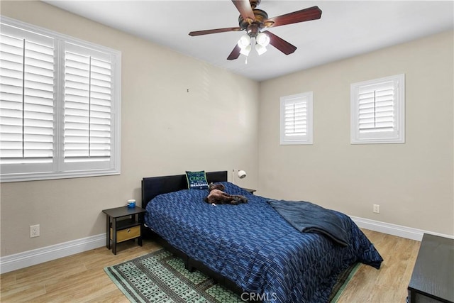 bedroom with hardwood / wood-style floors and ceiling fan