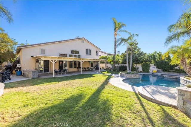 view of swimming pool featuring a patio area, a yard, and a jacuzzi