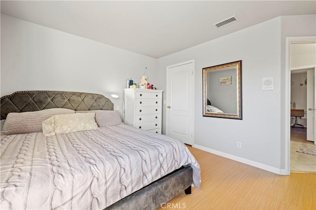 bedroom with hardwood / wood-style flooring