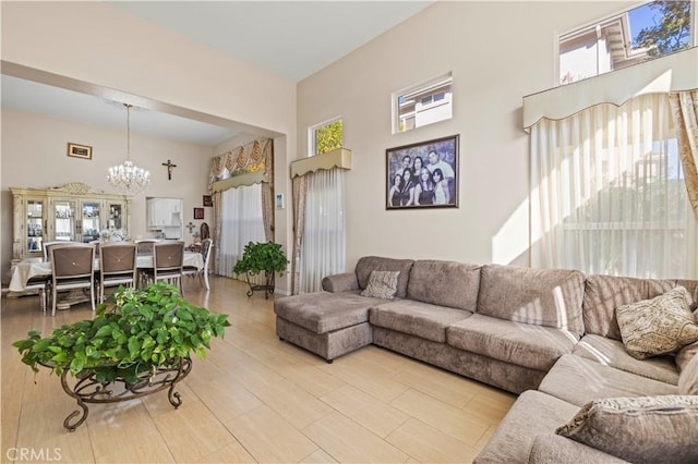 living room featuring a notable chandelier and a high ceiling