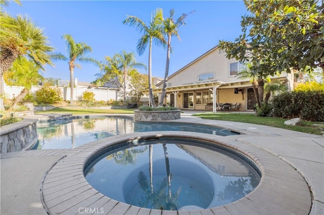 view of pool with an in ground hot tub