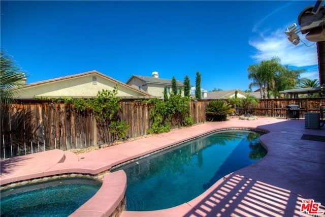 view of swimming pool featuring a grill