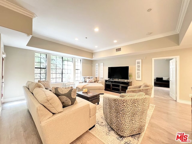 living room with light hardwood / wood-style floors and ornamental molding