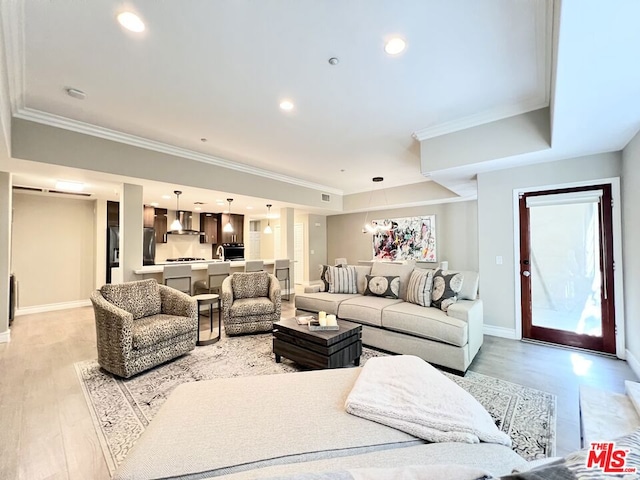 living room with light hardwood / wood-style floors and ornamental molding