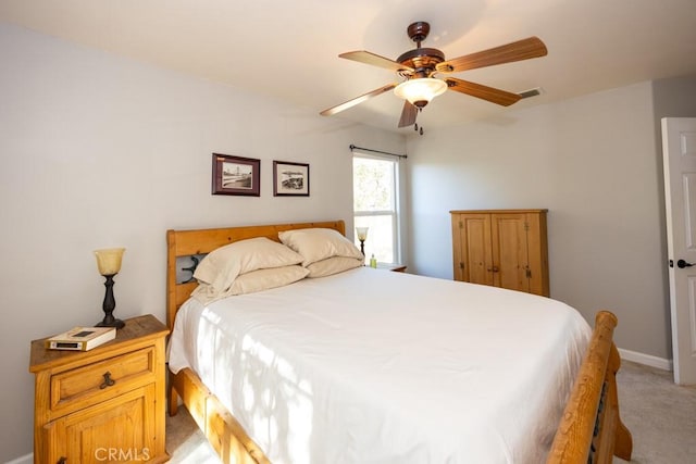 bedroom featuring light colored carpet and ceiling fan