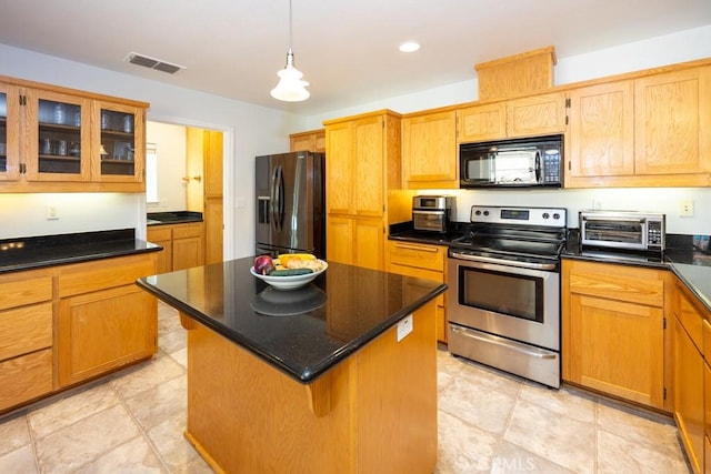 kitchen featuring decorative light fixtures, a center island, and appliances with stainless steel finishes