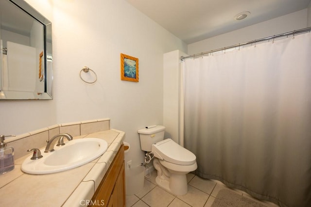 bathroom featuring toilet, vanity, and tile patterned floors