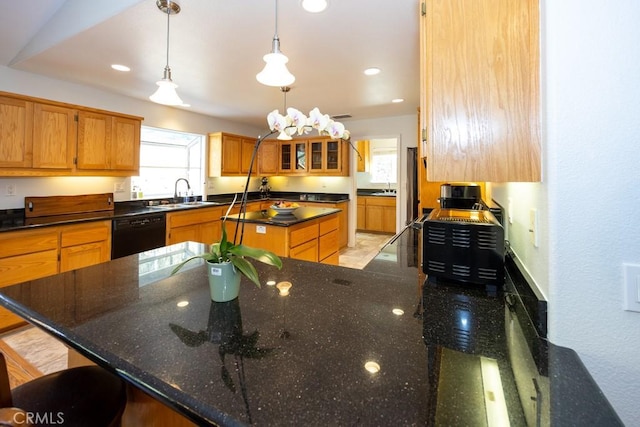 kitchen with pendant lighting, dark stone counters, a kitchen breakfast bar, sink, and black dishwasher