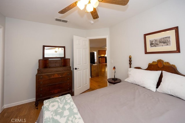 bedroom with ceiling fan and light hardwood / wood-style flooring