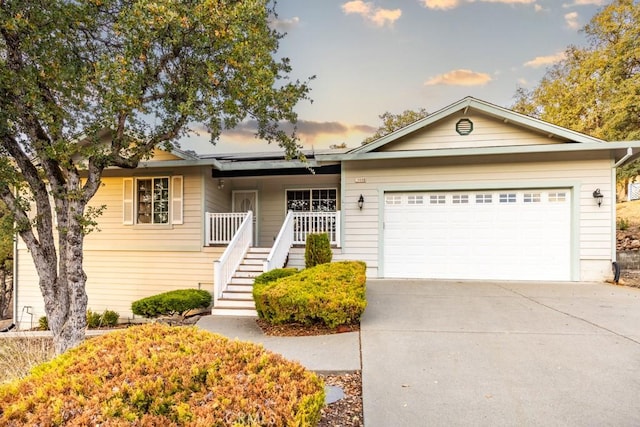 ranch-style home with covered porch and a garage