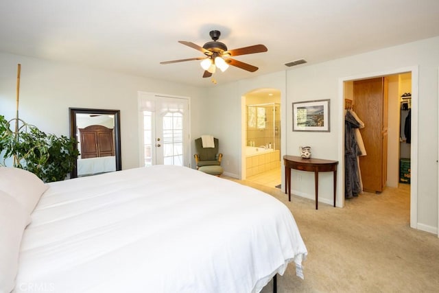 carpeted bedroom with ceiling fan and ensuite bath