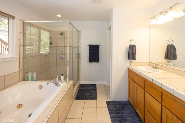 bathroom with tile patterned flooring, vanity, and separate shower and tub