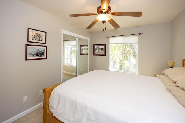 bedroom featuring a closet, ceiling fan, and light colored carpet