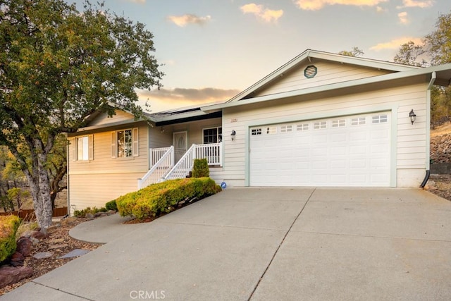 ranch-style house featuring a porch and a garage