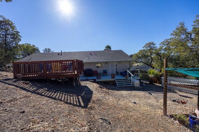 rear view of property featuring a deck