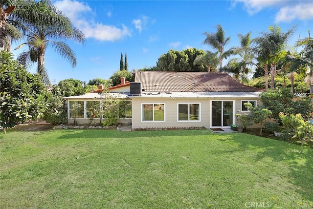 back of house with a lawn