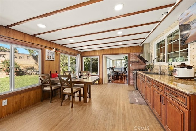 sunroom / solarium with beam ceiling, sink, and a wealth of natural light