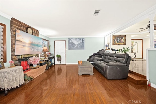 living room with wood-type flooring, ceiling fan, and ornamental molding