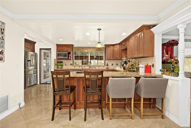 kitchen featuring light stone counters, kitchen peninsula, decorative backsplash, appliances with stainless steel finishes, and ornamental molding