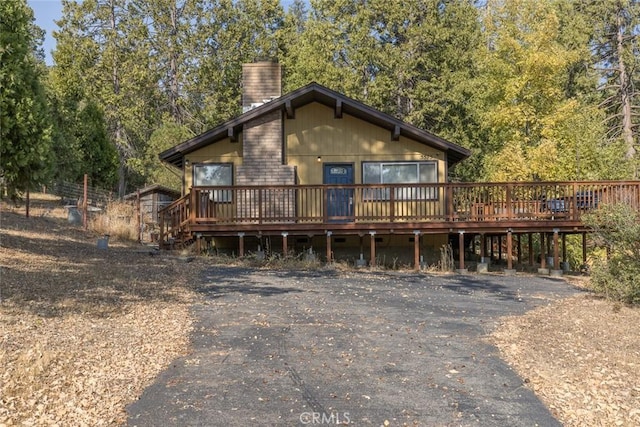 rear view of house with a wooden deck