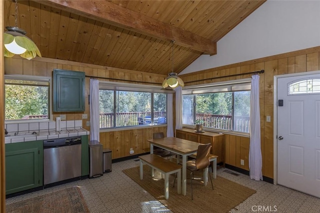 dining room with lofted ceiling with beams, wooden walls, and wood ceiling