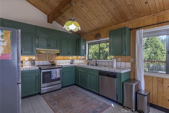 kitchen featuring tile countertops, lofted ceiling with beams, hanging light fixtures, and stainless steel appliances