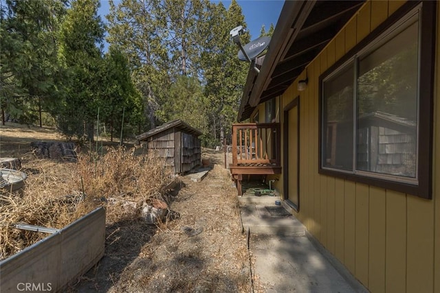 view of property exterior featuring a storage shed