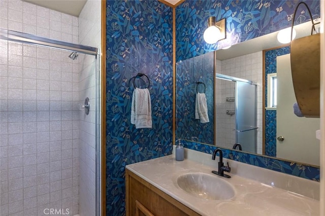 bathroom featuring vanity and a shower with shower door