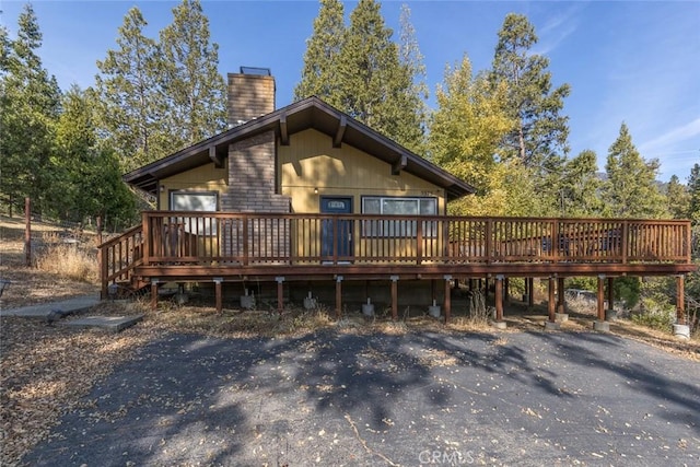 back of house featuring a deck