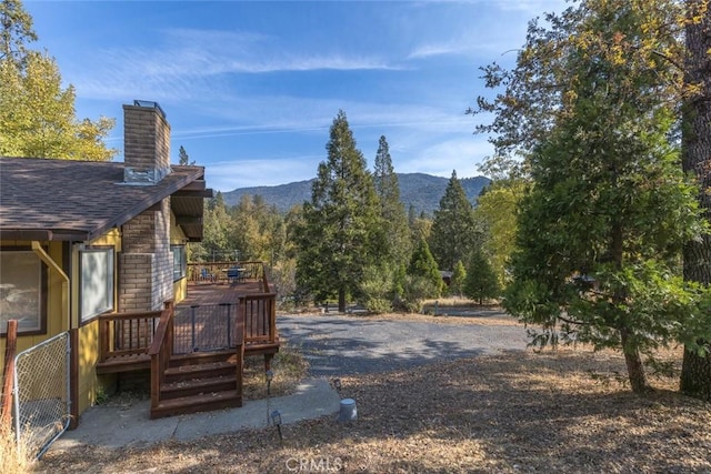 exterior space with a deck with mountain view