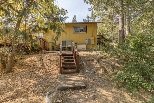 rear view of property featuring a deck