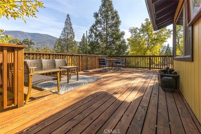 deck with a mountain view and an outdoor living space