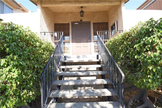 view of exterior entry with stucco siding