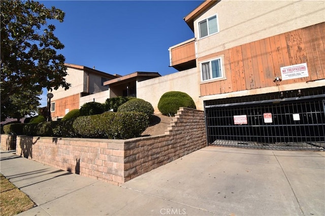 view of home's exterior with driveway and stucco siding