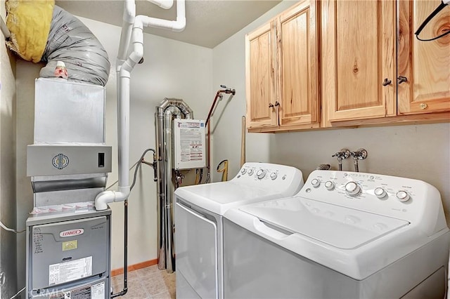 laundry area featuring washer and dryer and cabinets