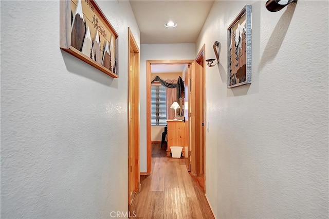 hall with light hardwood / wood-style floors