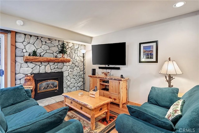 living room with light hardwood / wood-style flooring and a fireplace