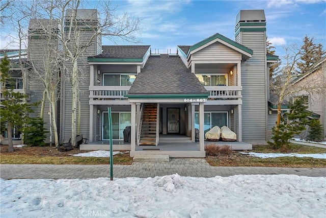 view of front of property featuring a porch and a balcony