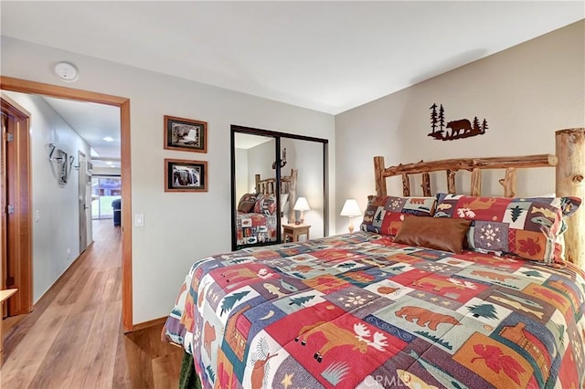 bedroom featuring a closet and light wood-type flooring