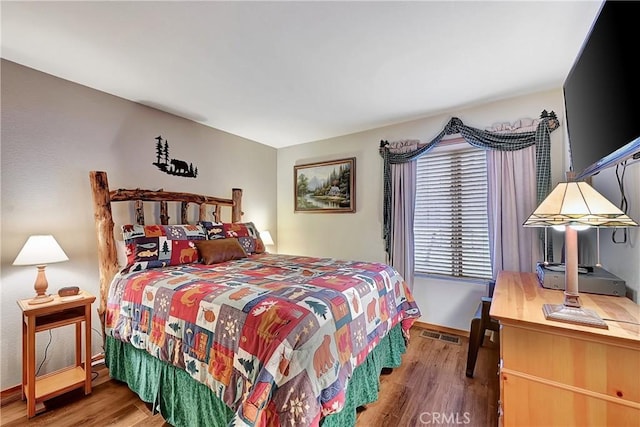 bedroom with hardwood / wood-style floors