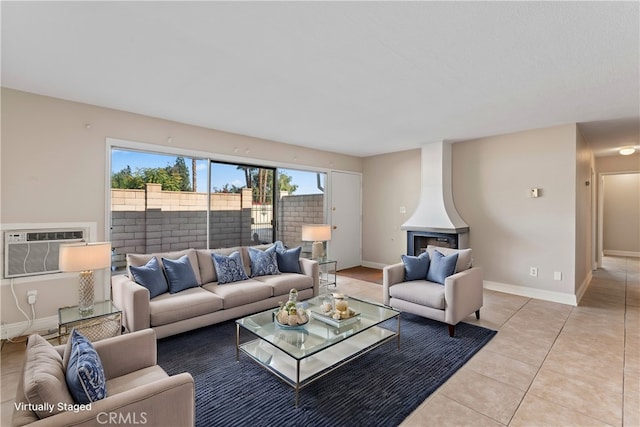 living room with light tile patterned floors, baseboards, and a wall mounted AC